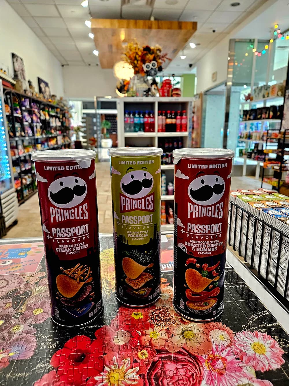 Wide view of Passport Candies store interior showing organized shelves filled with international candies and snacks